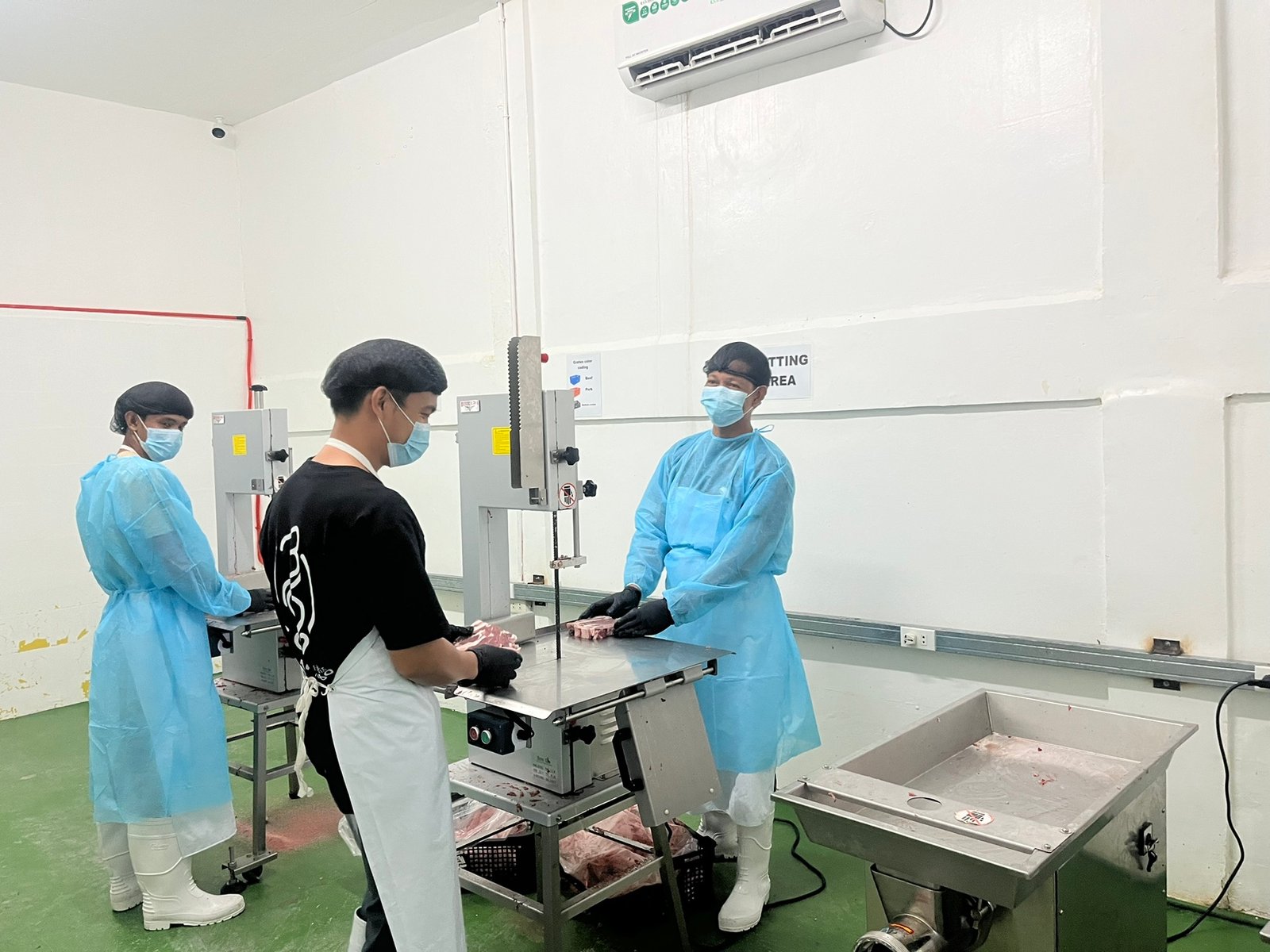 NE Meats butchers cutting meat in the cutting area