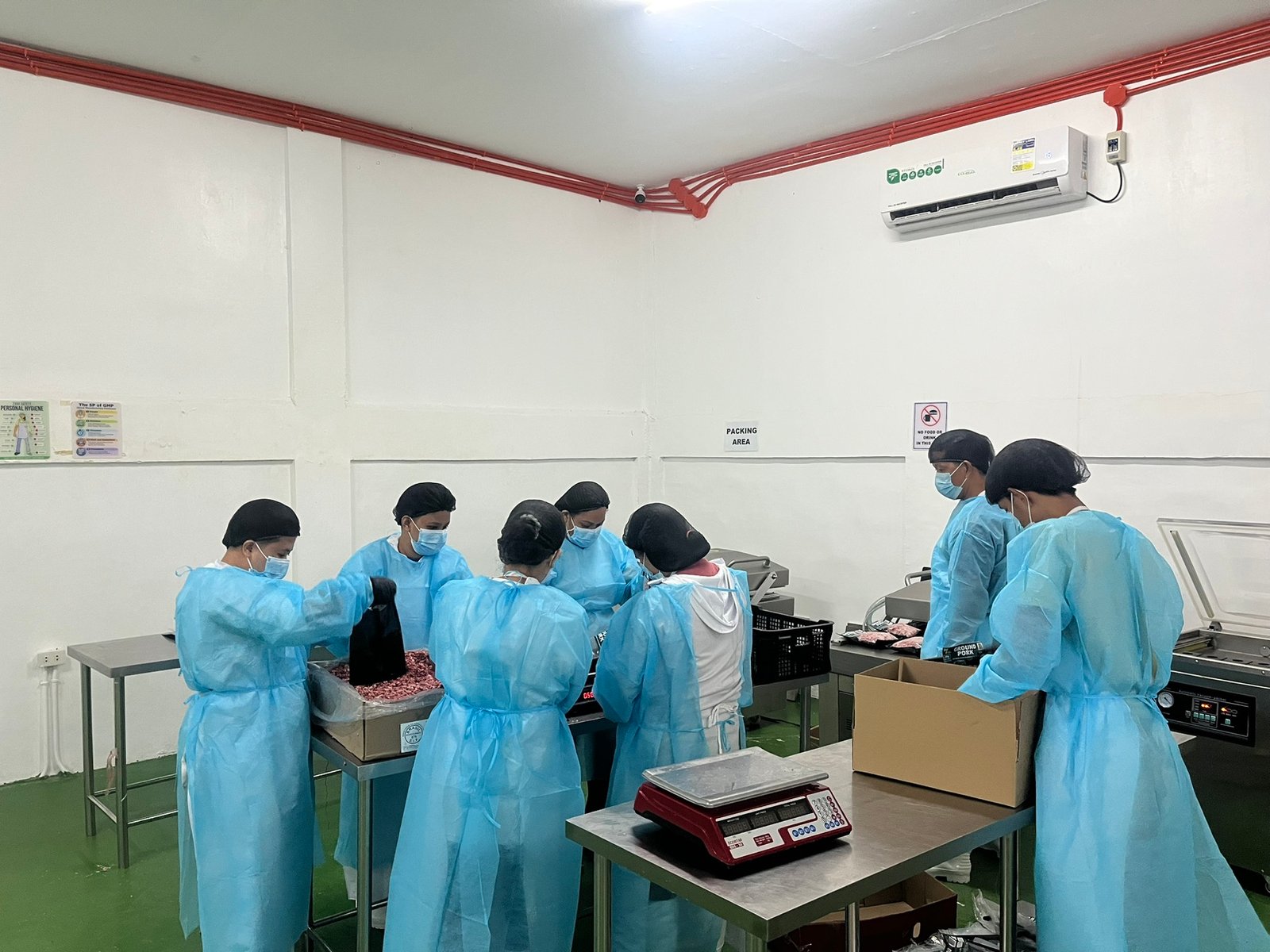 NE Meats staff preparing ground pork for packing