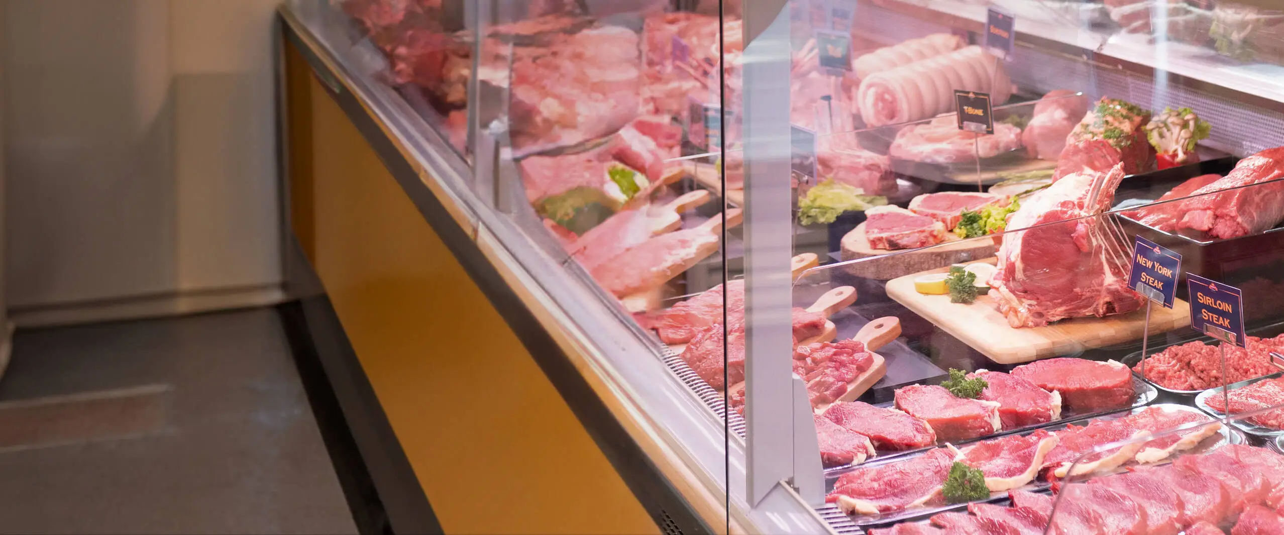 Fresh cuts of steak displayed in the shop case